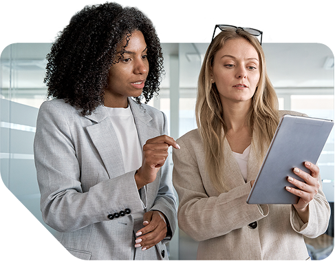 Two people in suits looking at a tablet